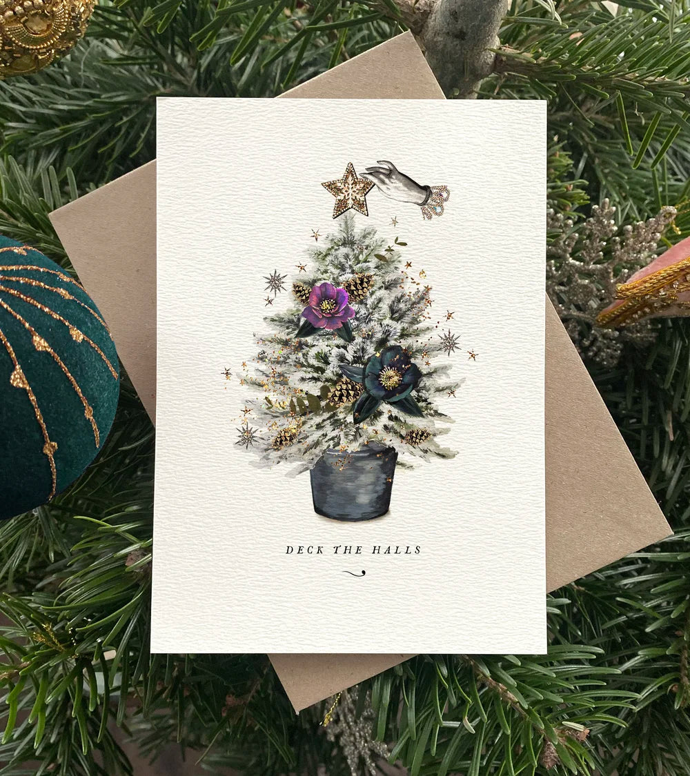 Christmas card with a festive tree design on a green leafy background