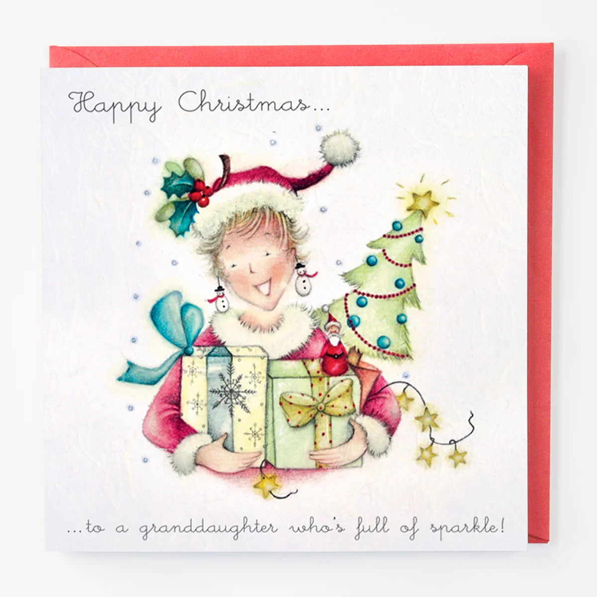 Christmas card with a child holding gifts and a decorated tree, with text 'Happy Christmas.