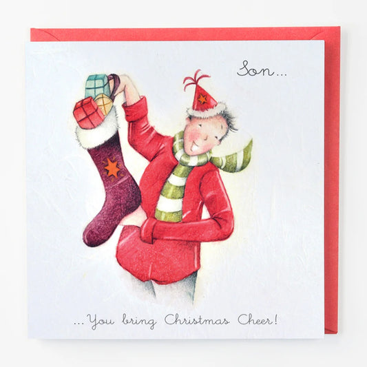 Christmas card with a person in red holding a purple stocking, wearing a Santa hat and scarf.